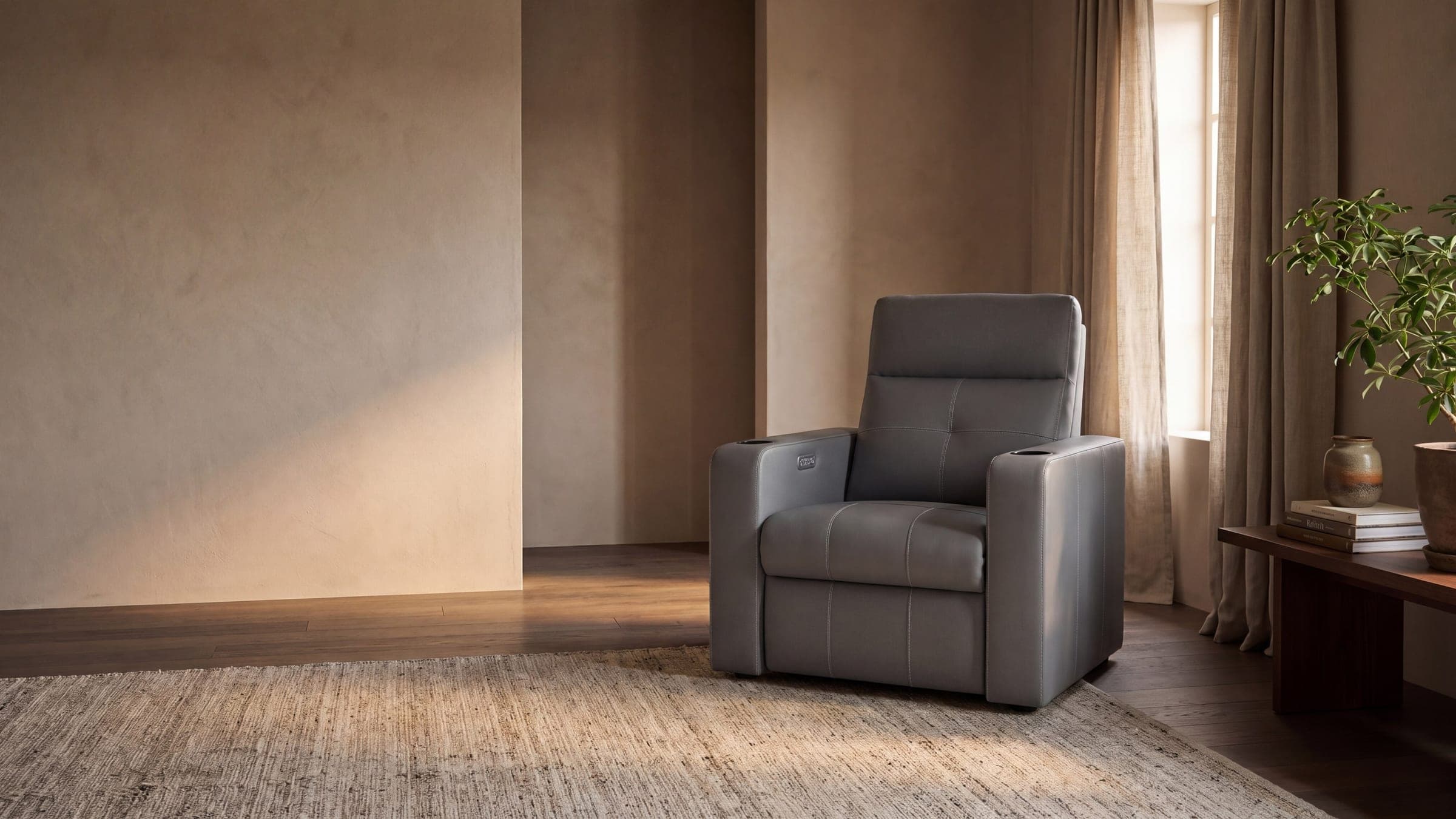 The Astra cinema recliner in a warm, dim media room