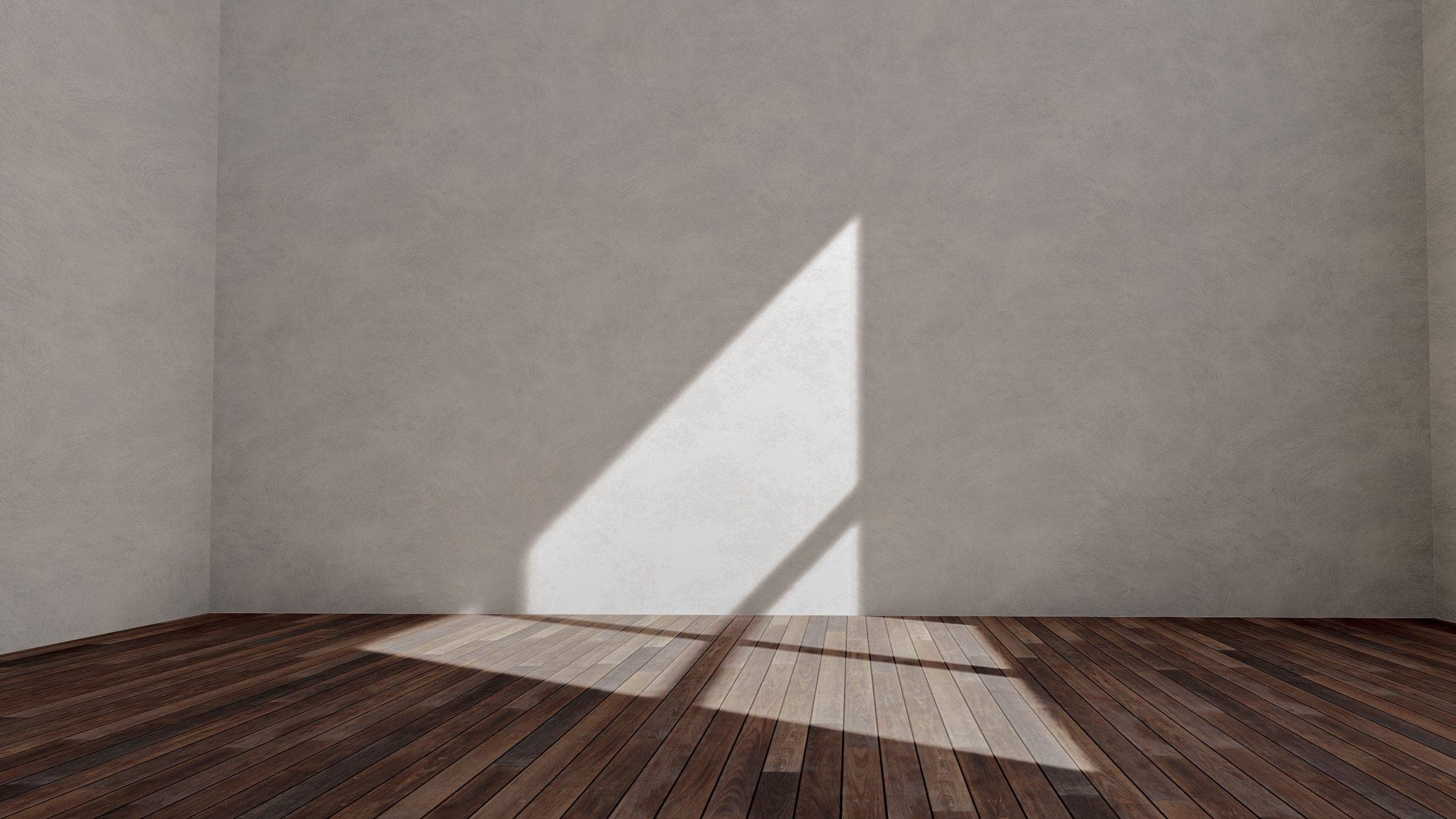 An empty room with a timber floor and a window