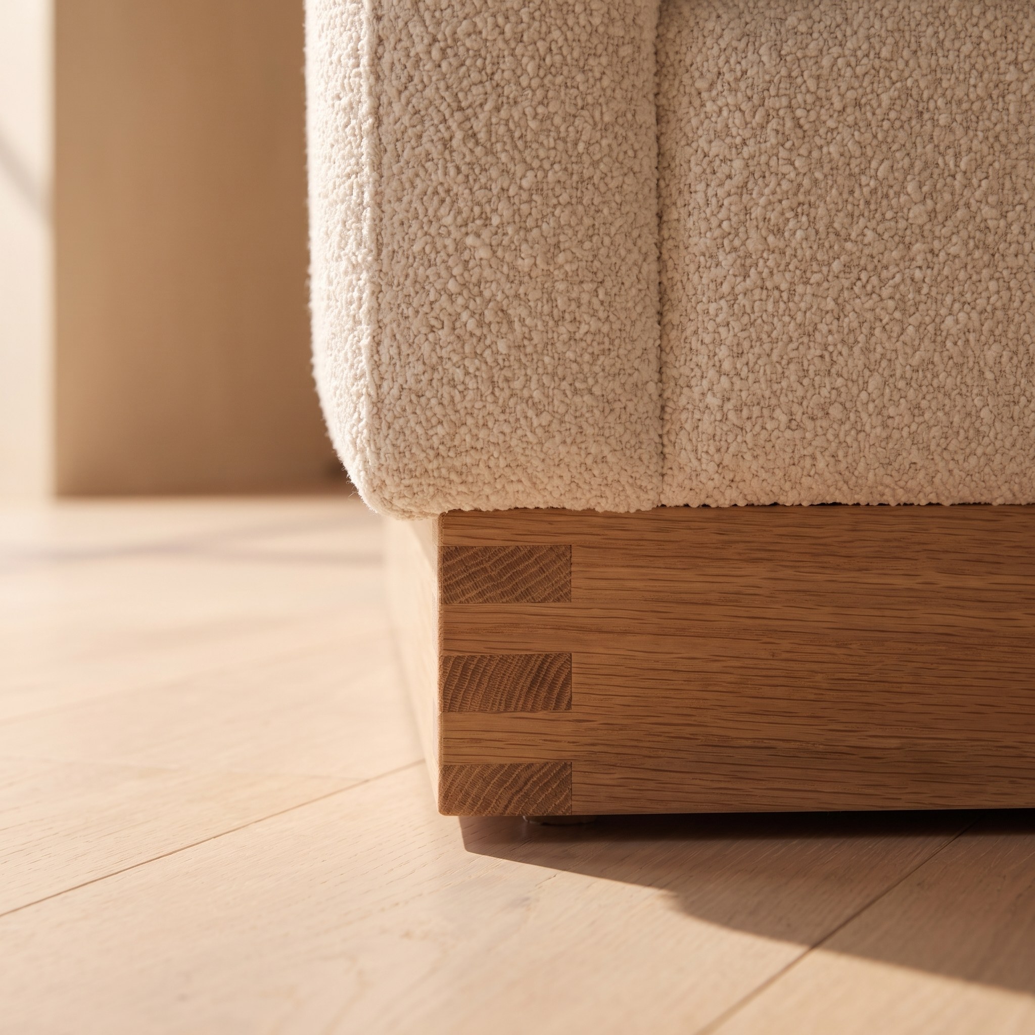 A close photograph of the joinery on Bouclé Three-Seat Sofa